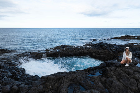 Woman in natural phenomenon of Bufadero de la Garita in Gran Canaria, spain