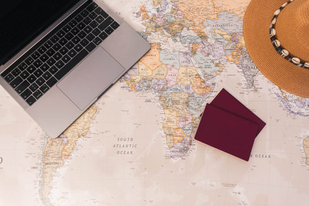 Desk world map with passports, laptop and hat, copy spaceの写真素材