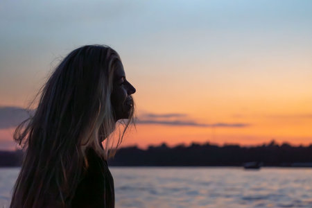 Carefree woman in the sunset on the boat. Vacation vitality living conceptの写真素材