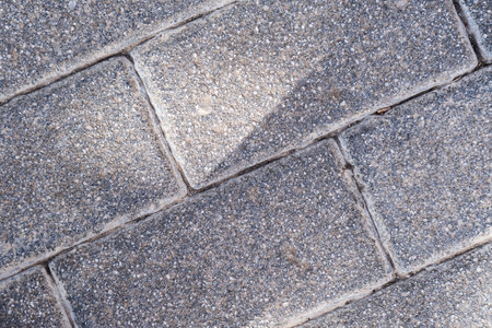 Concrete block background of old cobblestone pavement close-up.の写真素材