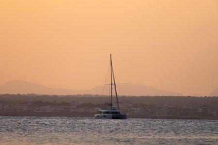Golden sunset on Mediterranean Sea. Nautical vessel in the sea