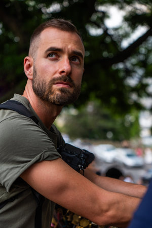 Caucasian man sitting in the city looking away