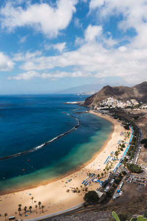 Aerial view of a serene beach in Tenerife with golden sand and clear blue waterの写真素材