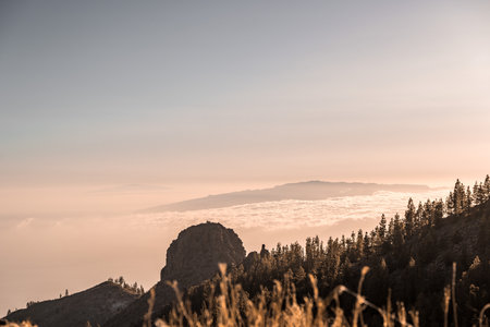Breathtaking view of Canary islands landscape, towering cliffs, clouds at sunset