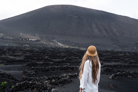 Woman in La Geria, vineyard wine landscape of volcanic in Lanzaroteの写真素材