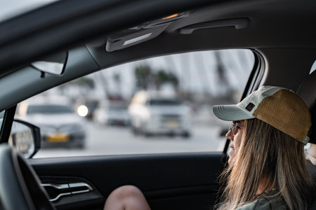 Tourist woman looking out car window at trafficの写真素材
