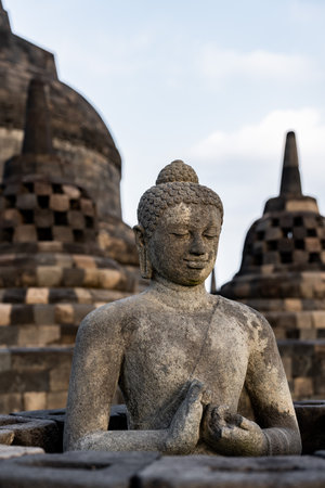 Stone buddha statue meditating inside borobudur templeの写真素材