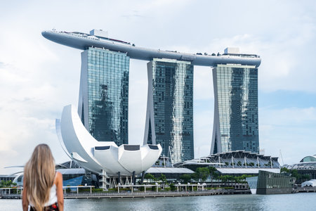 Tourist admiring the marina bay sands hotel and artscience museum in singaporeの写真素材