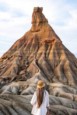 Rear view of tourist admiring castildetierra rock formation at bardenas reales natural park in spainの写真素材