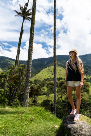 Woman enjoying the scenic beauty of colombias cocora valley