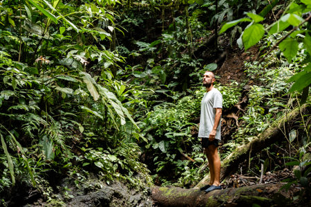 Tourist man exploring lush colombian rainforest: embracing natures beauty
