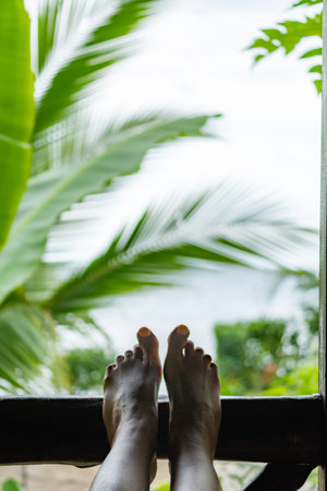 Tourist relaxing with feet up enjoying lush colombian sceneryの写真素材