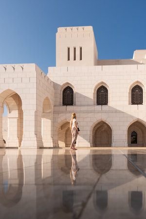 Woman exploring sultan qaboos grand mosque in omanの写真素材