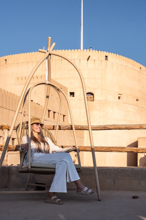 Woman relaxing on swing chair enjoying oman travel lifestyleの写真素材