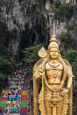Batu caves murugan statue and colorful temple stepsの写真素材