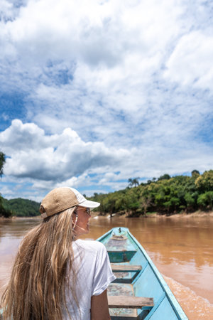 Woman enjoying river travel by longtail boat