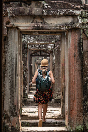 Woman exploring ancient temple ruins in southeast asiaの写真素材