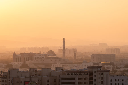 Muscat city skyline showing mosques and buildings at sunsetの写真素材