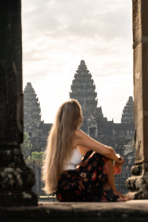 Woman watching iconic angkor wat temple at sunriseの写真素材