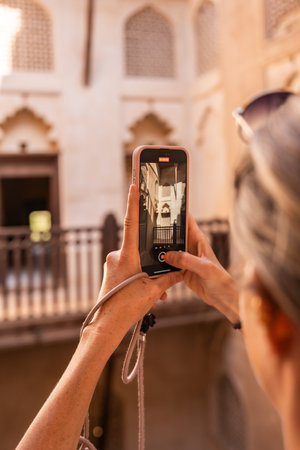 Close up of woman recording video with smartphone while traveling in omanの写真素材