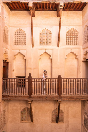 Woman traveling balcony historic architecture nizwa fort omanの写真素材