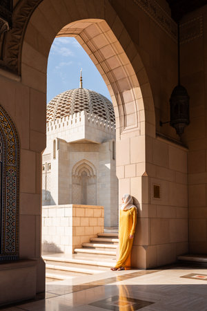 Woman traveling in sultan qaboos grand mosque in omanの写真素材