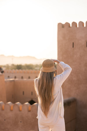 Woman traveling in oman exploring ancient Nizwa fortの写真素材