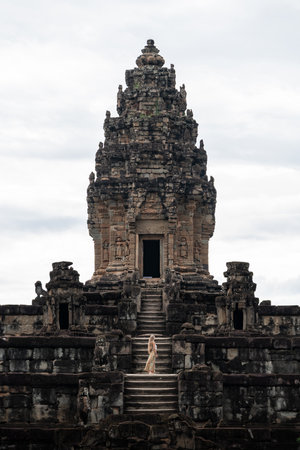 Woman exploring ancient temple ruins in cambodiaの写真素材
