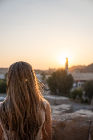 Woman admiring oman sunset view travel lifestyleの写真素材
