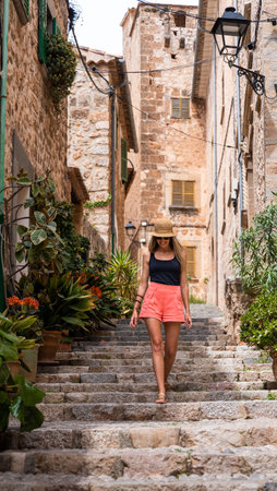 Caucasian woman with long blonde hair walking through the ancient village