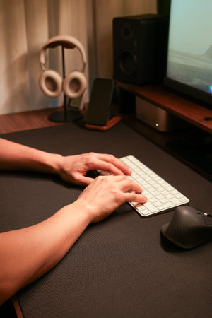 Person typing keyboard working home office setup