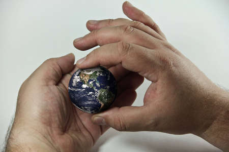 hands holding a globeの写真素材