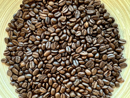 Coffee beans on a wooden plate, can be used as backgroundの写真素材