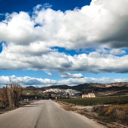 Country road with blue sky and white clouds. Spain, Costa Bravaの写真素材