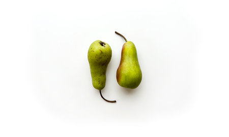 Yin and yang green pears isolated on white background. Perfect and not ideal pears placed as number 69 together top view. Quotation markの写真素材