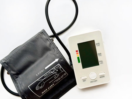 Blood pressure monitor and stethoscope on white background, studio shot