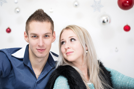 young woman and a young man with Christmas decorationのeditorial素材
