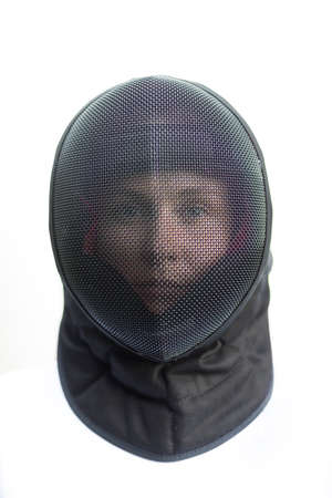 Closeup of black metal mask (helmet) on female full face head for electric and non-electric sabre...