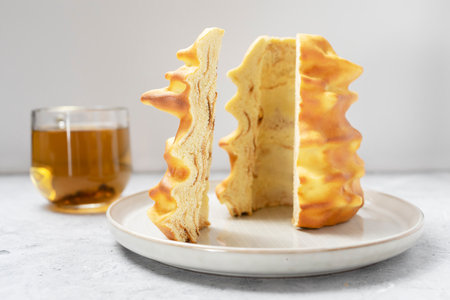 Cut piece of Sakotis ,sekacz, baumkuchen, traditional spit cake in lithuanian, polish, german,...