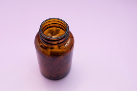 Prebiotics Softgel Capsules Of Slippery Elm In Brown Glass Bottle On Purple Violet Background, Copy Space for Text. Herbal medicine, Ulmus Fulva, Natural Remedy. Horizontal planeの写真素材