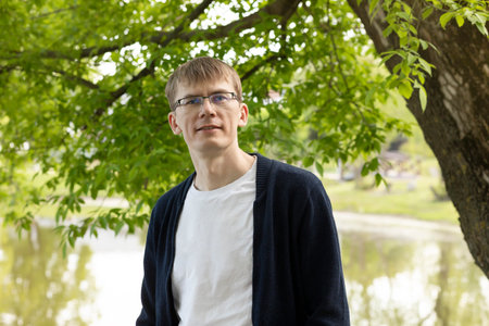 Portrait Of Tall Blond 40 Yo Man In Eyesight Glasses, Smiling Looking At Camera, Green Tree And Lake...