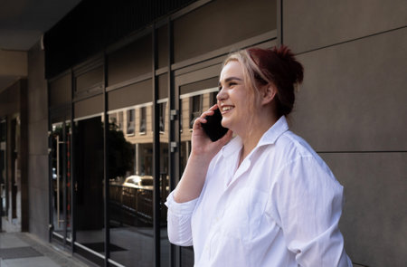 Real Happy 20s Plus Size Pretty Girl Talking on Phone. Smiling Young Caucasian Woman Enjoys...