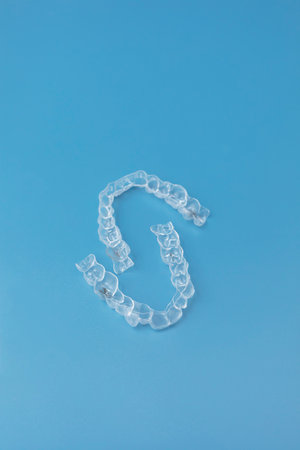 Mouth guard. Transparent dental aligners for mans maxillary and mandibular teeth on blue background....