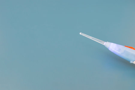 Mockup Top View Ear Wax Removal Glass Stick Or Curette on Blue Background, Copy Space For text....