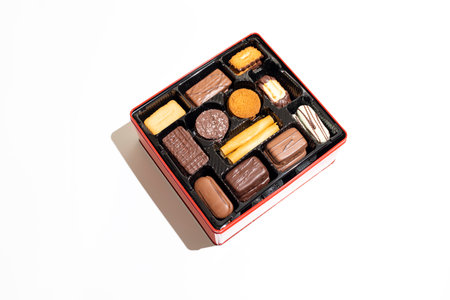 Isolated Assorted shortbread Belgian Cookie in Red Box on White Background. Festive holiday Dessert Assortment. Flat lay 12 Sections feature delicious treats like Christmas Biscuits. Horizontal Planeの写真素材