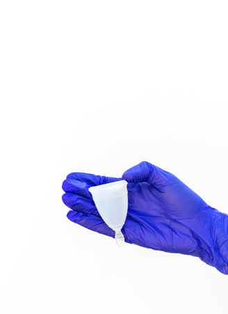 Design World Menstrual Hygiene Day On May, 28. Isolated Human Hand in Glove Holds Menstrual Cup on...