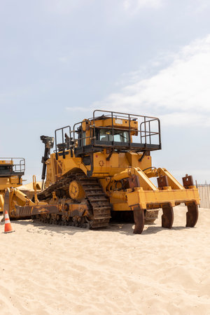 Yellow Crawler Dozer On Sandy Beach, Blue Sky On Background. Bulldozer Builds Roads. Construction...