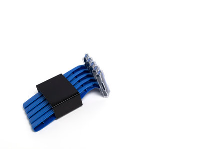 Mockup Isolated Set of Disposable Blue Plastic Razors On White Background, Copy Space, Horizontal. Personal Daily Hygiene. Blue Shaver For Man. Selective Focus. Removal Of Unwanted Hair. Package.の写真素材
