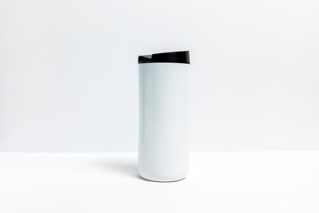 Isolated Metal Coffee Travel Mug with Black Cap On White Background. Thermal Cup For Beverage Or Drinks, Horizontal Plane. Stainless Steel Thermos. Backdropの写真素材
