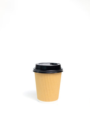 Isolated Mockup Brown Beige Paper Drinks Mug, Cup with Black Lid On White Background. Eco Hot Beverage Tumbler, Vertical Plane, Copy Space. On the Go Food Service Applicationの写真素材